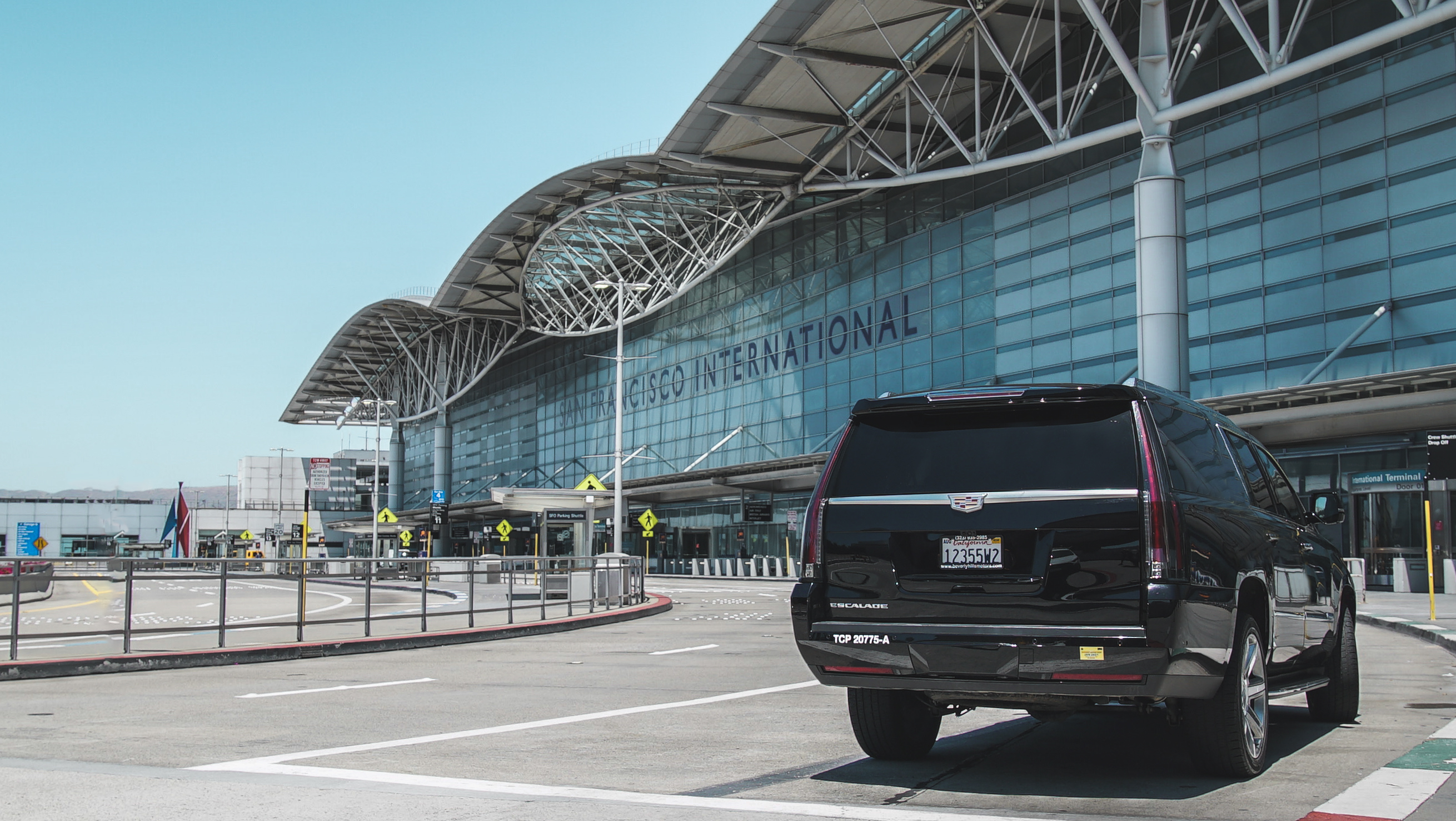 Black luxury vehicle in front of the San Francisco International Airport